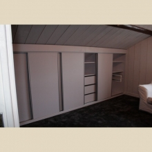 closet with sliding door under the bevel of the ceiling, interior